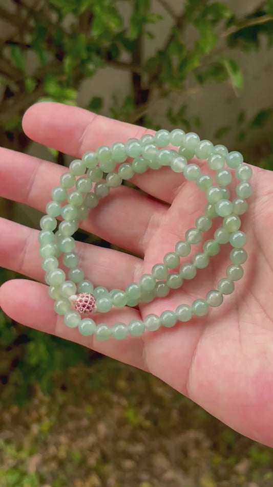 Video showcasing the soft glassy luster and elegant icy imperial white and apple green color palette of the 6.2mm certified Burmese jade bead necklace JN011