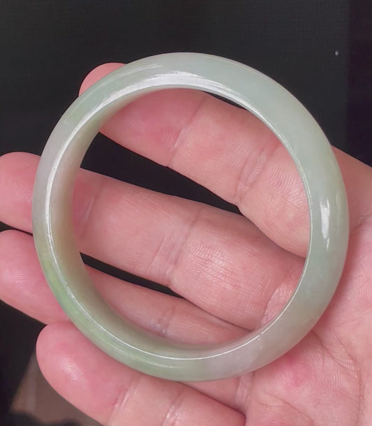 Video showcasing the bright glassy luster and fine crystalline texture of icy apple green and milky white Burmese jadeite bangle JB079