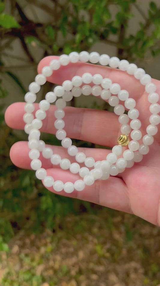Video showcasing the soft glassy luster and elegant icy milky white and light apple green color palette of the 6.8mm certified Burmese jade bead necklace JN013