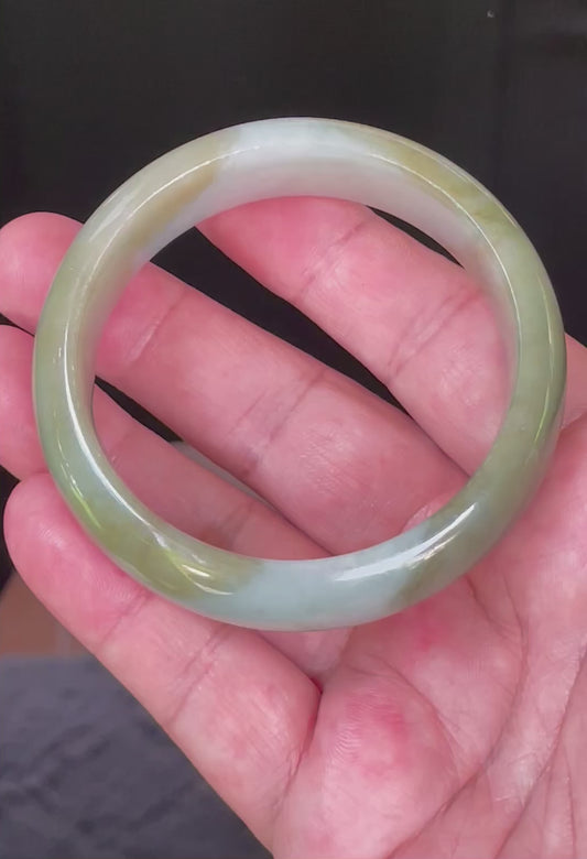 Video showcasing the bright glassy luster and fine crystalline texture of icy apple green, moss green, and bluish milky white Burmese jadeite bangle JB032