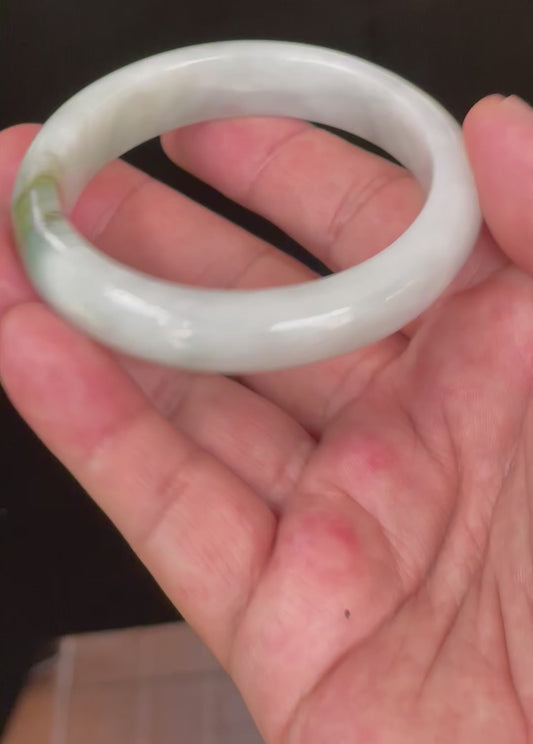 Video showcasing the bright glassy luster and fine crystalline texture of icy apple green, moss green, and light greyish milky white Burmese jadeite bangle JB025