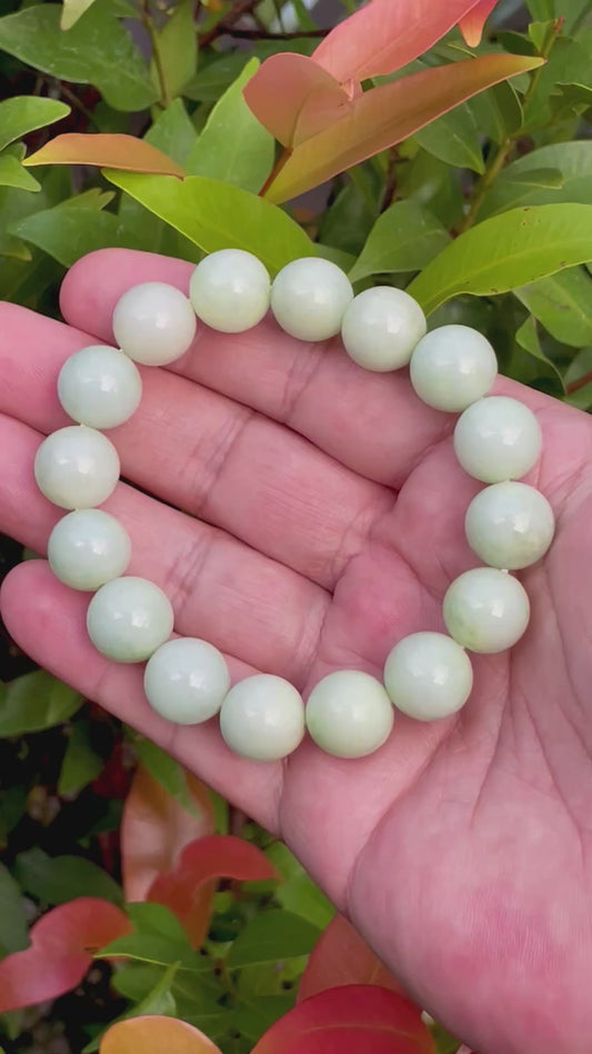 Video showcasing the vitreous luster and balanced fusion of icy apple green, forest green, and milky white hues of the 13.4mm Burmese jade bead bracelet JBB172