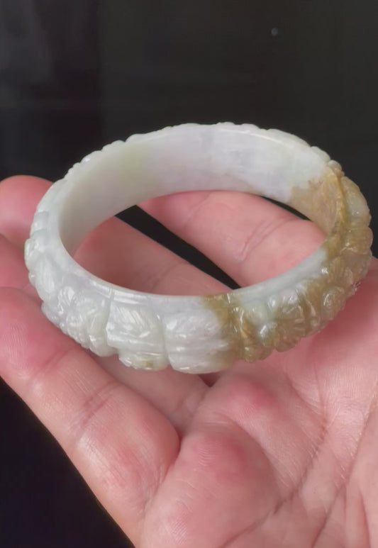 Video showcasing the matte-glossy luster and beautiful icy forest green, honey orange, and white hues of the 58.7mm hand-carved floral Burmese jade bangle JB206