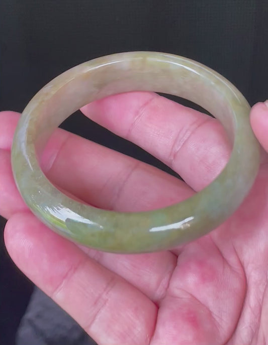Video showcasing the bright glassy luster and fine crystalline texture of icy apple green, forest green, and milky honey white Burmese jadeite bangle JB040