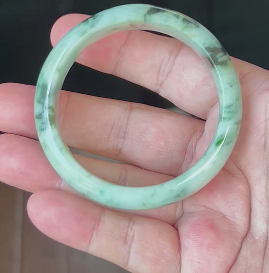 Video showcasing the natural glassy luster and fine crystalline texture of icy apple and forest green Burmese jadeite bangle JB543