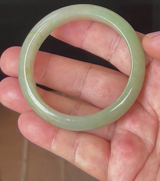 Video showcasing the natural glassy luster and fine crystalline texture of icy apple green and honey Burmese jadeite bangle JB506
