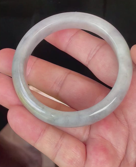 Video showcasing the natural glassy luster and fine crystalline texture of icy grey, milky white, and honey Burmese jadeite bangle JB358