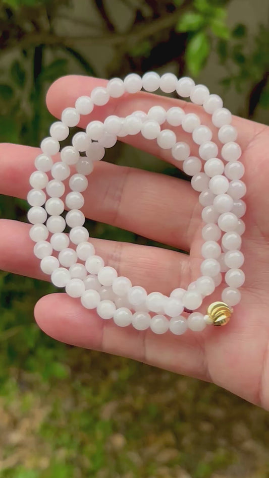 Video showcasing the soft glassy luster and elegant icy milky white and light apple green color palette of the 6.4mm certified Burmese jade bead necklace JN014