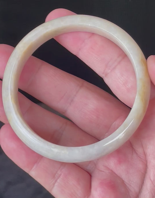 Video showcasing the vitreous luster and fine crystalline texture of icy yellow, honey, milky white, and light lavender Burmese jadeite bangle JB926