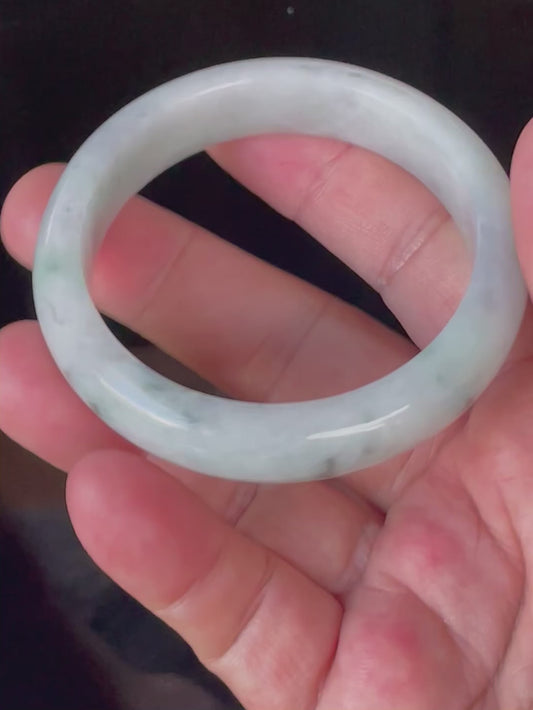 Video showcasing the bright glassy luster and fine crystalline texture of icy apple green and greyish milky white Burmese jadeite bangle JB920