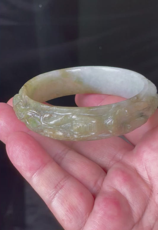 Video showcasing the glassy luster and beautiful icy apple and forest green hues of the 58.9mm hand-carved dragon Burmese jade bangle JB208