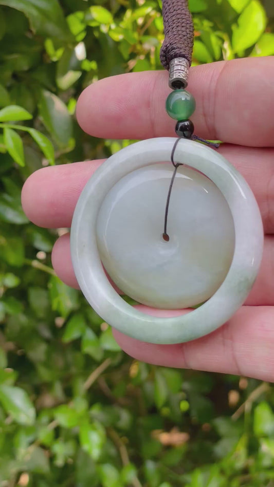 Video showcasing the smooth polish, milky white and soft green hues, and modern dual-ring bi disc shape of the Burmese jade pendant JP060