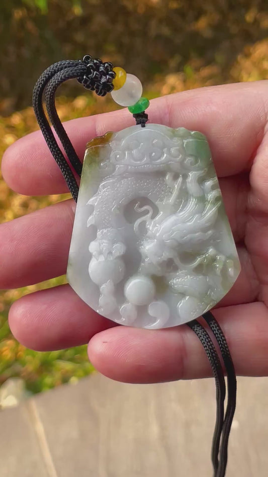 Video showcasing the vitreous luster, green, milky white, and golden brown hues, and hand-carved dragon motif of the certified Burmese jade pendant JP081