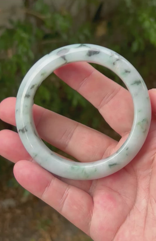 Video showcasing the natural luster and moss in snow patterns of icy white Burmese jadeite bangle JB1315