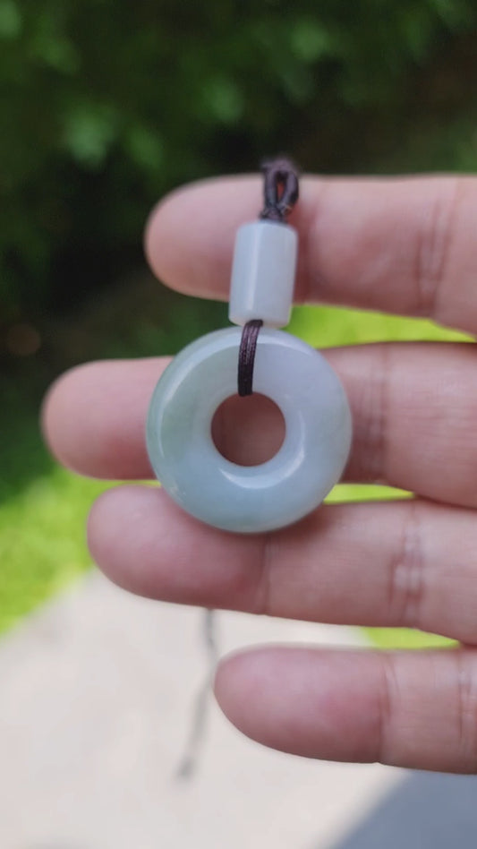 Video showcasing the vitreous luster, icy lavender and imperial green hues, and traditional donut swirl shape of the Burmese jade pendant JP024