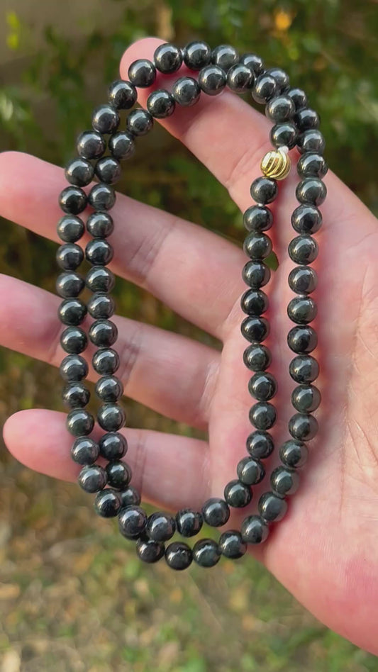 Video showcasing the soft glassy luster and elegant icy deep forest and apple green color palette of the 7.3mm certified Burmese jade bead necklace JN095