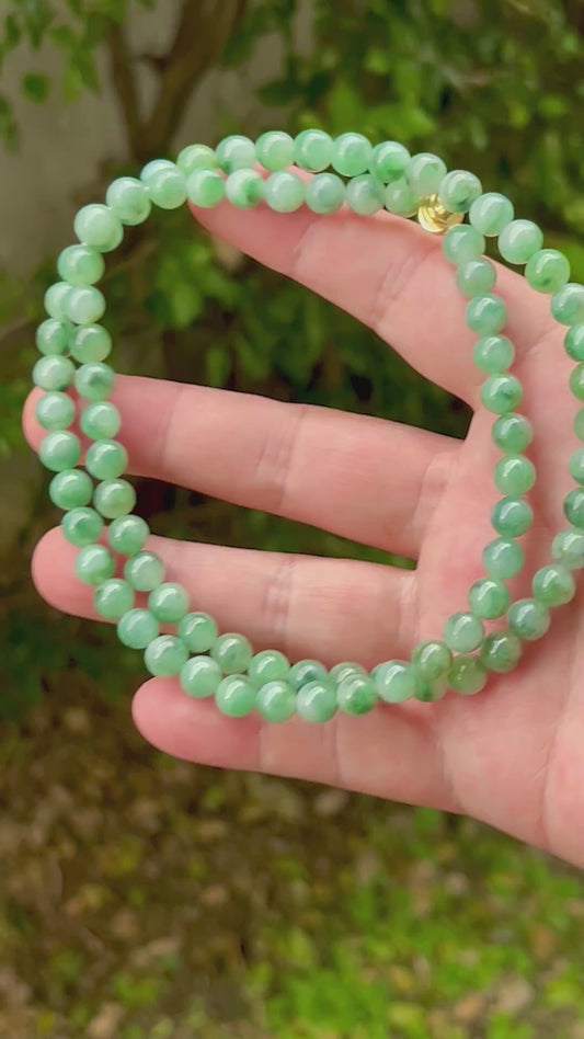 Video showcasing the soft glassy luster and elegant "Moss in the Snow" color palette of the 7.5mm certified Burmese jade bead necklace JN004