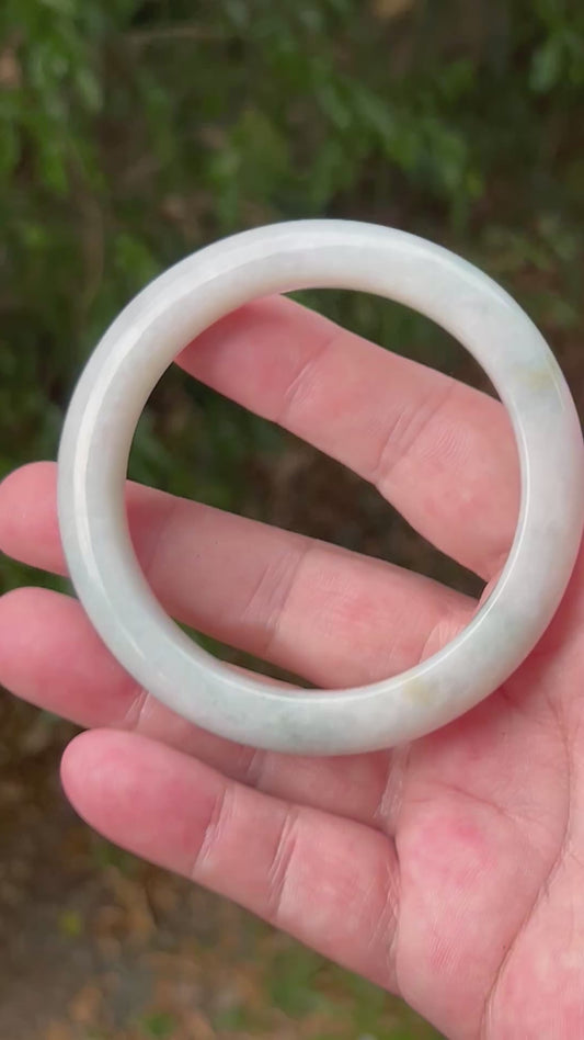 Video showcasing the natural luster and pale celadon green hues of icy milky white Burmese jadeite bangle JB1314