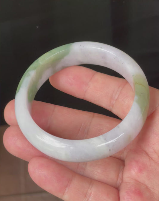 Video showcasing the natural glassy luster and fine crystalline texture of icy greyish milky white, apple and forest green Burmese jadeite bangle JB095