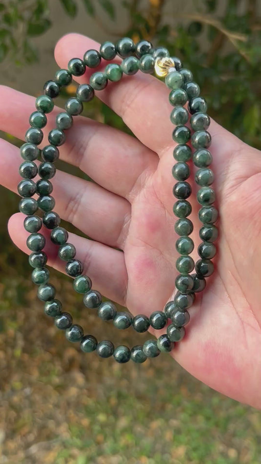 Video showcasing the soft glassy luster and elegant icy deep forest and apple green color palette of the 7.6mm certified Burmese jade bead necklace JN096