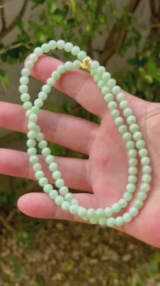 Video showcasing the soft glassy luster and elegant icy imperial white and apple green color palette of the 6mm certified Burmese jade bead necklace JN005
