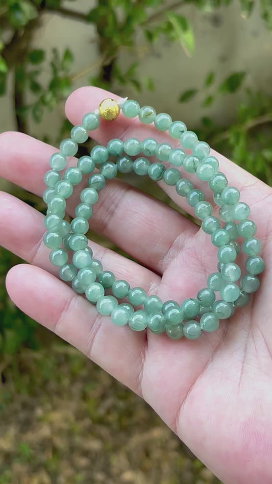 Video showcasing the soft glassy luster and elegant icy imperial white and apple green color palette of the 6.4mm certified Burmese jade bead necklace JN018