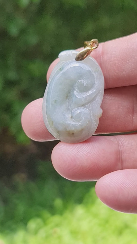 Video showcasing the smooth soft sheen, bluish milky white hues, and hand-carved Ruyi Swirl motif of the vintage Burmese jade pendant JOP002