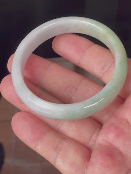 Video showcasing the natural glassy luster and fine crystalline texture of icy light lavender, milky white, apple and imperial green Burmese jadeite bangle JB356