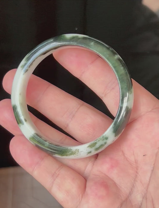 Video showcasing the natural glassy luster and fine crystalline texture of icy deep forest green and milky white Burmese jadeite bangle JB559