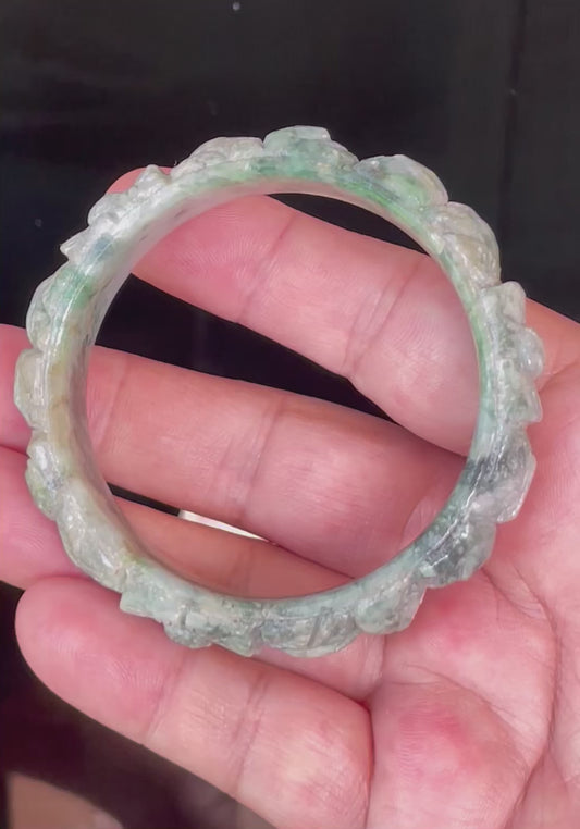Video showcasing the glassy luster and beautiful icy emerald and imperial green hues of the 56mm hand-carved floral Burmese jade bangle JB443