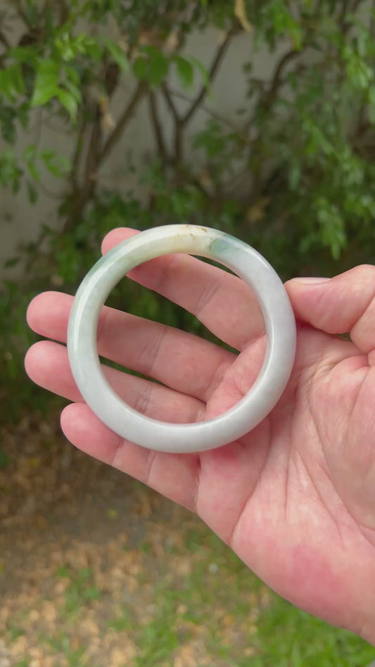 Video showcasing the natural luster and honey green patterns of icy white Burmese jadeite bangle JB1290