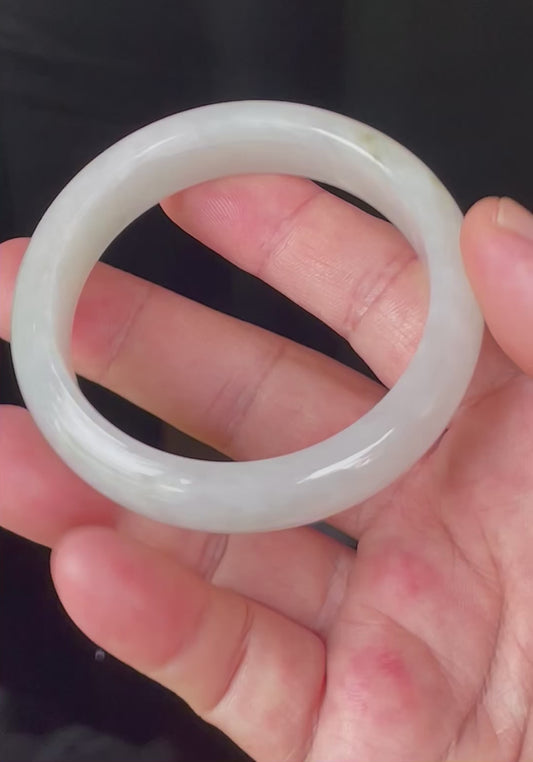 Video showcasing the bright glassy luster and fine crystalline texture of icy apple green, milky white, and imperial green dotted Burmese jadeite bangle JB103