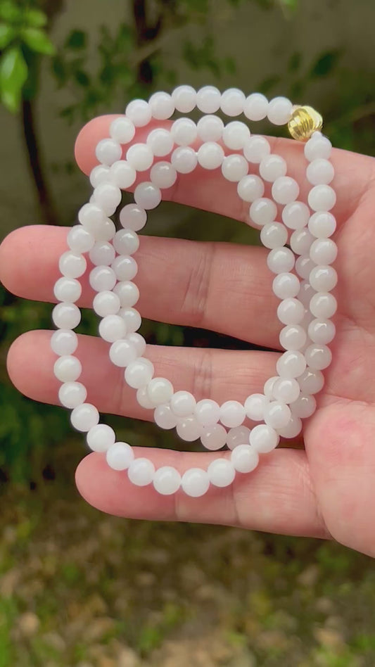 Video showcasing the soft glassy luster and elegant icy milky white and light apple green color palette of the 6.2mm certified Burmese jade bead necklace JN015