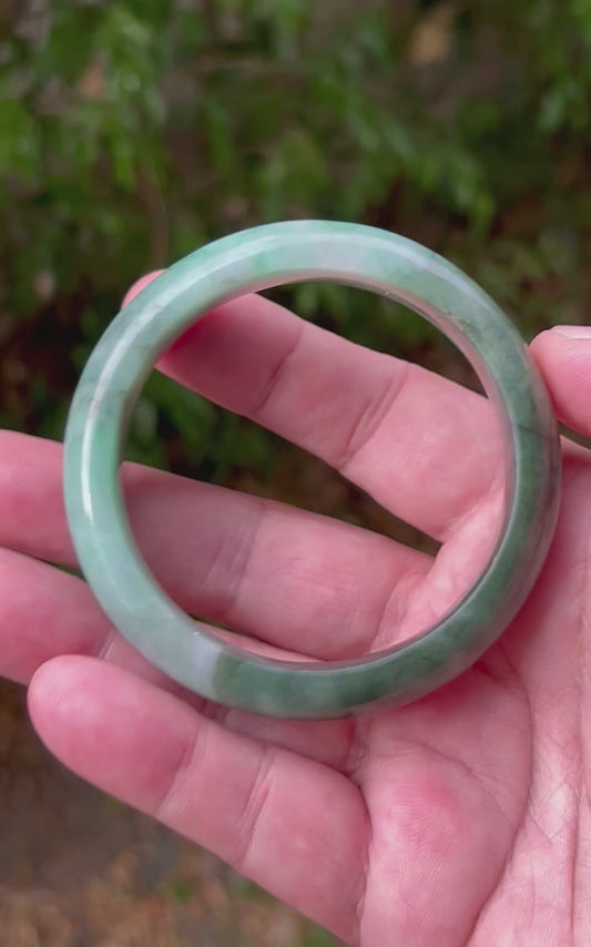 Video showcasing the natural luster and moss in snow patterns of icy bluish green Burmese jadeite bangle JB1320