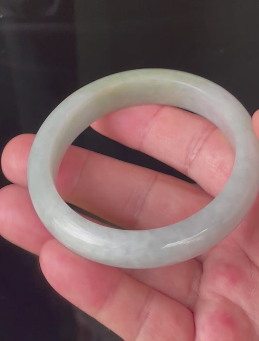 Video showcasing the natural glassy luster and fine crystalline texture of icy apple green, greyish milky white, and light lavender Burmese jadeite bangle JB203