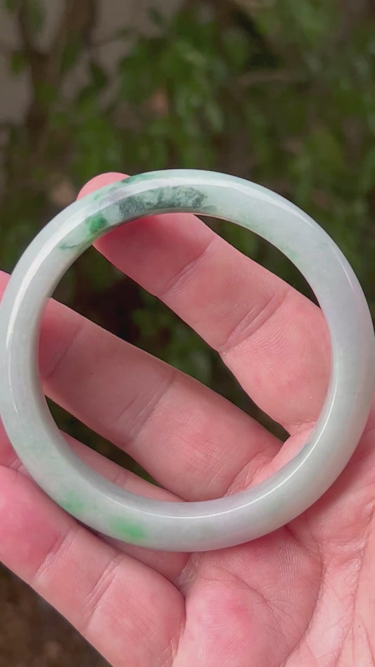 Video showcasing the natural luster and moss in snow patterns of icy green Burmese jadeite bangle JB1316