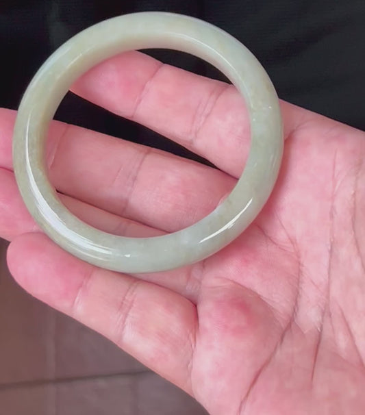 Video showcasing the natural glassy luster and fine crystalline texture of icy apple green Burmese jadeite bangle JB558