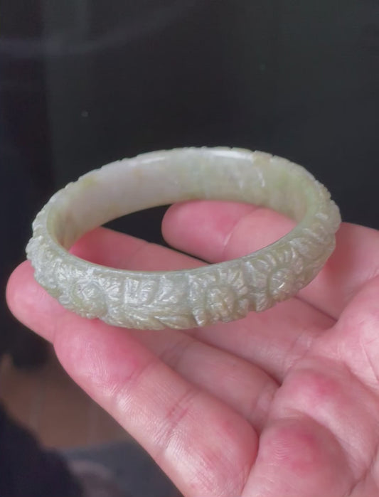 Video showcasing the matte-glossy luster and beautiful icy apple green and milky white hues of the 57.4mm hand-carved floral Burmese jade bangle JB207
