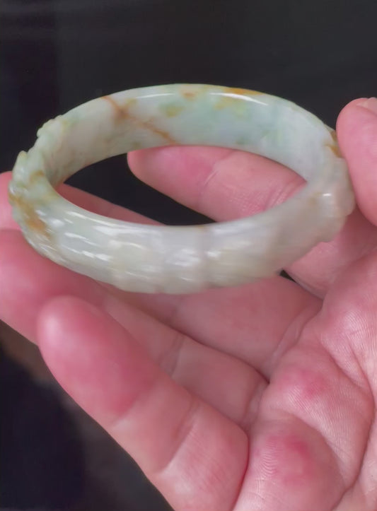 Video showcasing the matte-glossy luster and beautiful icy apple green, white, and honey hues of the 57mm hand-carved floral Burmese jade bangle JB210