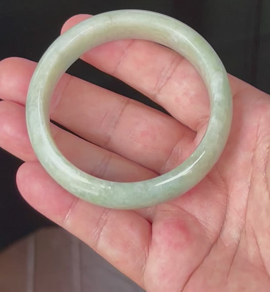 Video showcasing the natural glassy luster and fine crystalline texture of icy light apple green and milky white Burmese jadeite bangle JB536