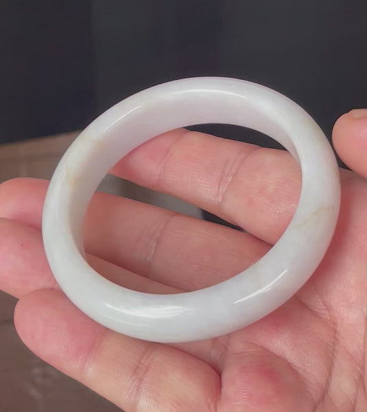 Video showcasing the natural glassy luster and fine crystalline texture of icy light lavender, milky white and honey Burmese jadeite bangle JB359