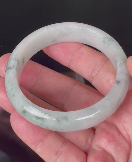 Video showcasing the vitreous luster and fine crystalline texture of greyish milky white, apple green, and imperial green Burmese jadeite bangle JB831