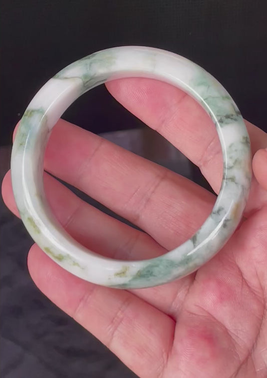 Video showcasing the vitreous luster and fine crystalline texture of icy imperial green, apple green, and milky white Burmese jadeite bangle JB877