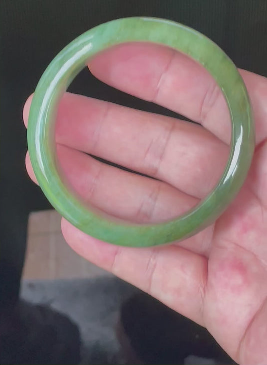 Video showcasing the bright glassy luster and fine crystalline texture of icy emerald and apple green Burmese jadeite bangle JB043