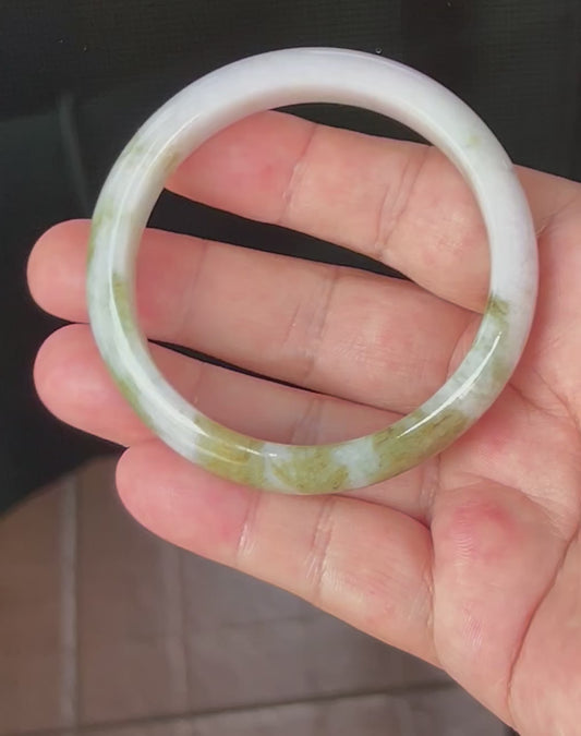 Video showcasing the natural glassy luster and fine crystalline texture of icy milky white and moss green Burmese jadeite bangle JB535