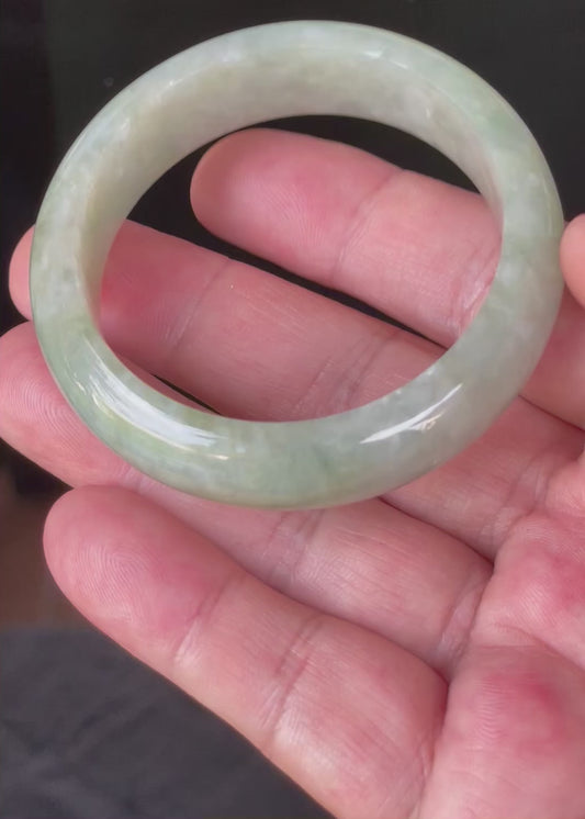 Video showcasing the natural glassy luster and fine crystalline texture of icy apple green and milky white Burmese jadeite bangle JB238