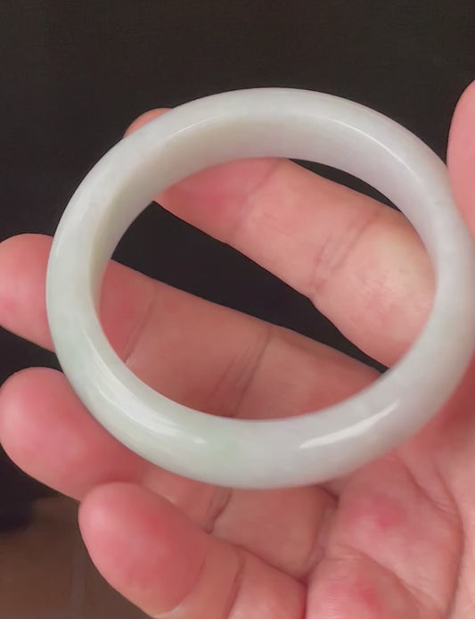 Video showcasing the bright glassy luster and fine crystalline texture of icy light apple green and milky white Burmese jadeite bangle JB900