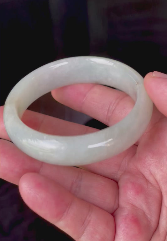 Video showcasing the bright glassy luster and fine crystalline texture of very icy apple green and imperial green line Burmese jadeite bangle JB200