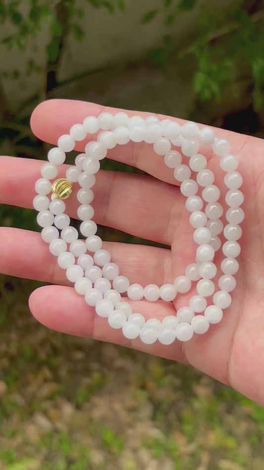 Video showcasing the soft glassy luster and elegant icy milky white and light apple green color palette of the 6.2mm certified Burmese jade bead necklace JN017