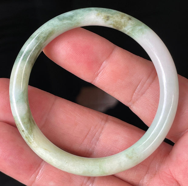 Solid icy white, forest, and apple green natural Type A Burmese jade bangle bracelet in size 50.7mm